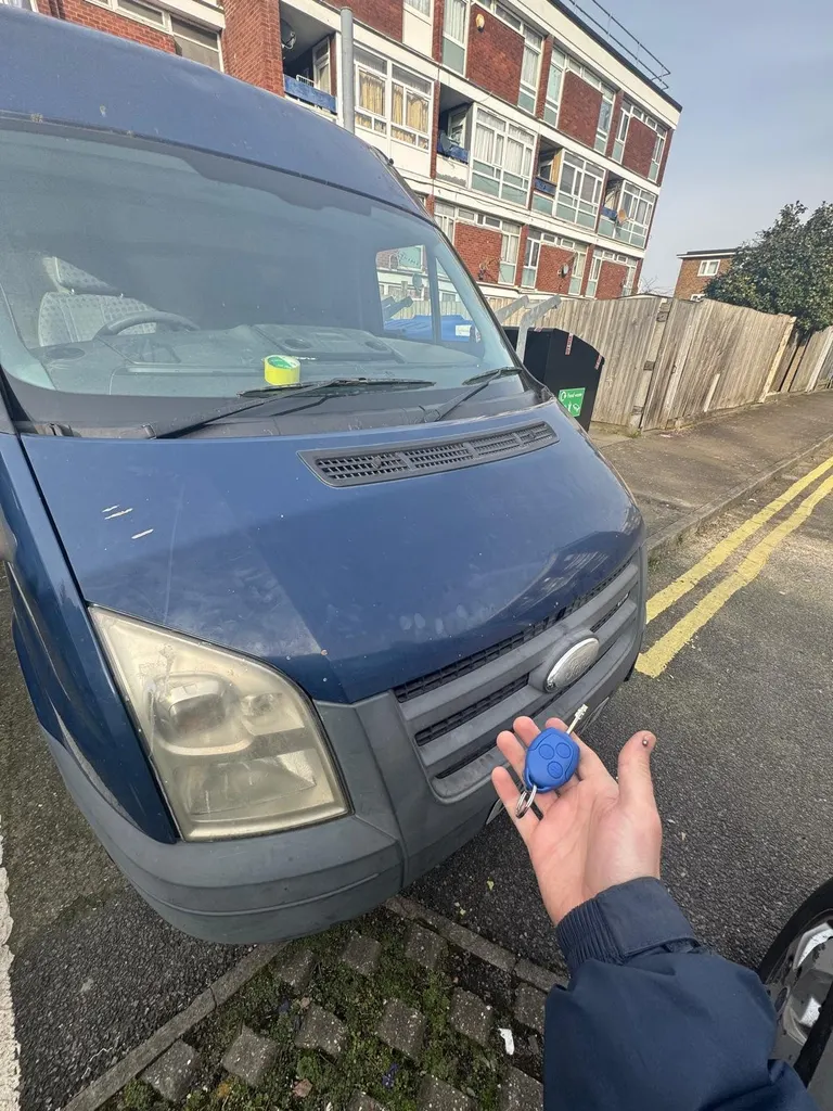 Ford Transit van with its key held in front of the bonnet after a mobile key job