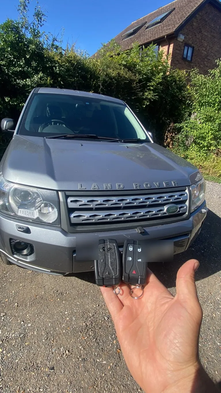 Two Land Rover Freelander 2 keys held in front of the car after a spare key was cut and programmed in Edenbridge