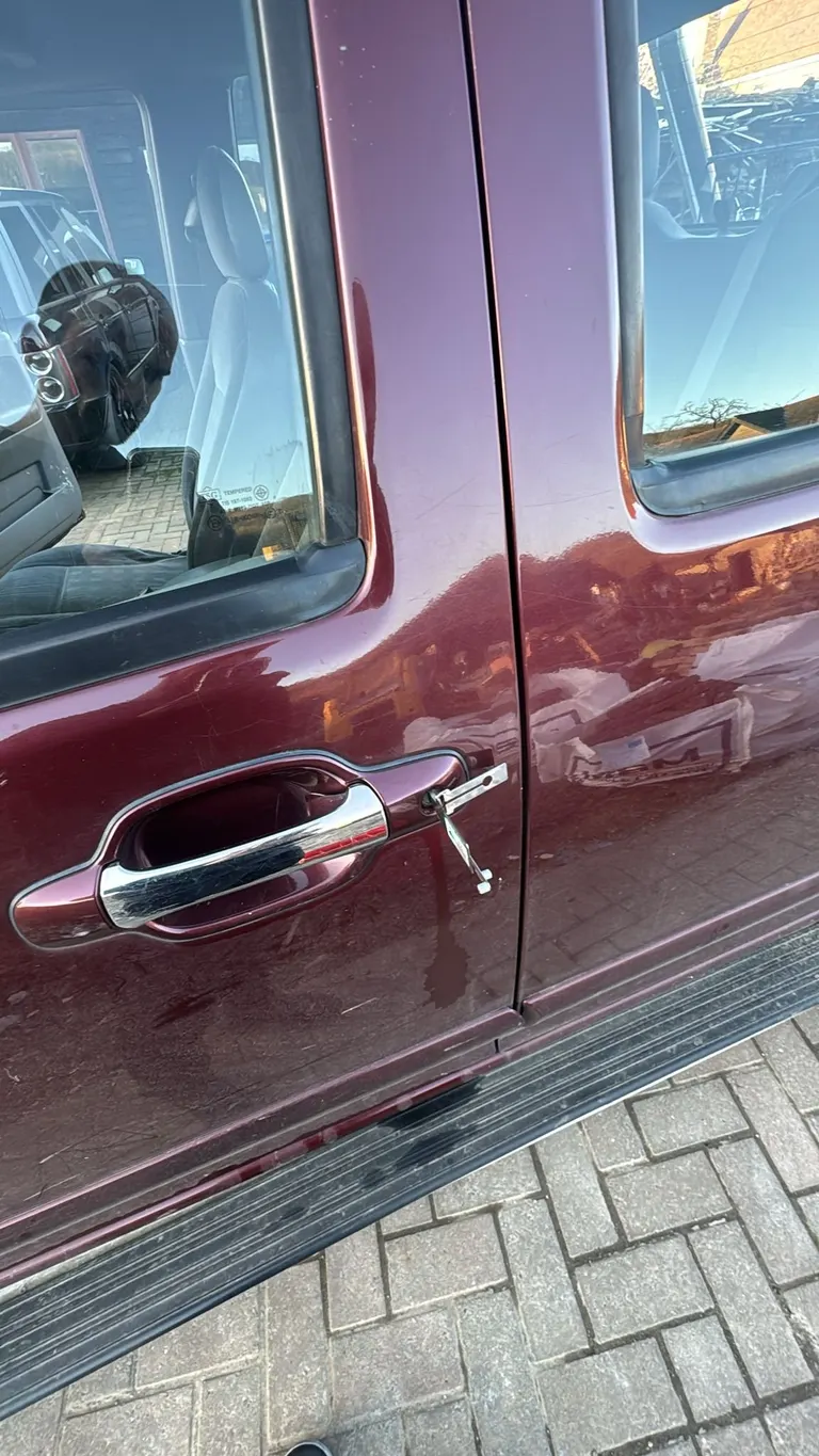 Key in the driver's door lock of a maroon Mercedes Vito during a door lock repair in Dartford